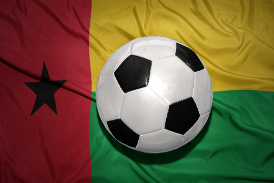 black and white football ball on the national flag of guinea bissau