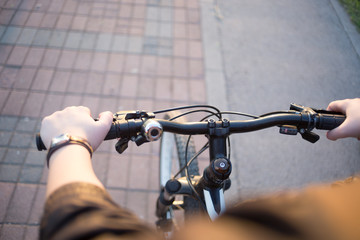 focus on hands and bicycle at park - close up