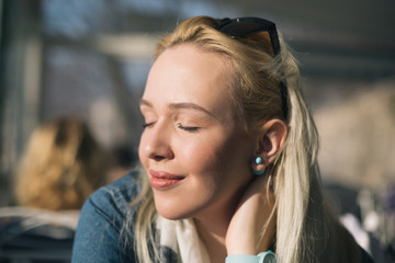 Fototapeta premium Rest, relax, enjoy. The girl in the summer courtyard cafe. Loung