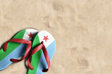 Thongs with flag of Djibouti, on beach sand