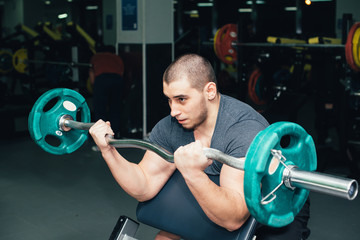 Fototapeta na wymiar man goes in for sports, fitness in the gym