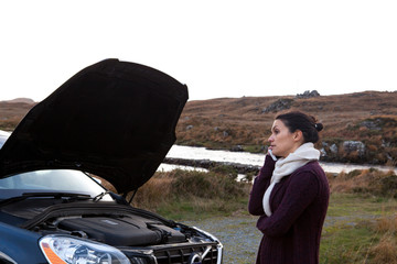 Woman by stalled vehicle at roadside, Connemara, Ireland