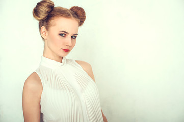 Close-up portrait beautiful girl. with funny hairstyle. Sly and scheming young woman face...