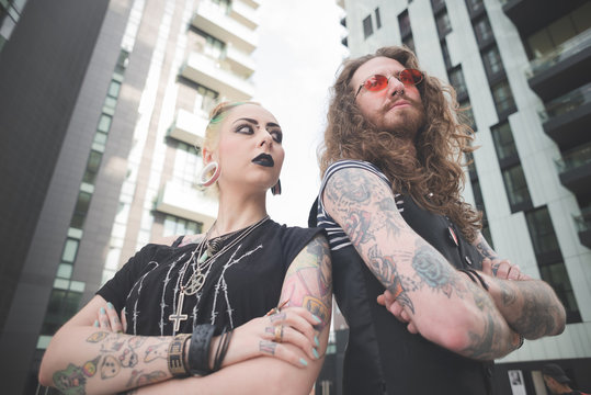 Low angle view of punk hippy couple with tattoos