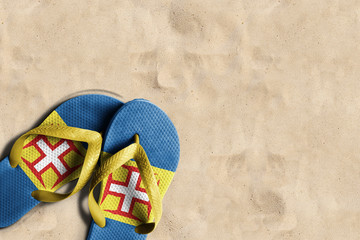 Thongs with flag of Madeira, on beach sand