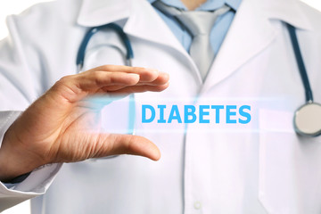 Doctor holding text diabetes in his hand, closeup