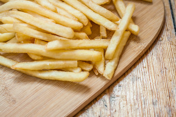 Fast food set big hamburger and french fries on wood background