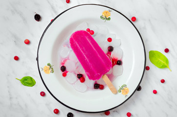 Berry ice cream on a marble with ingredients
