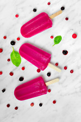 Berry ice cream on a marble with ingredients