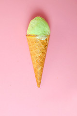 Pistachio ice cream on a pink background