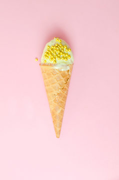 Pistachio ice cream on a pink background with gold decoration