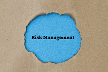 Risk Management written under burnt torn paper.