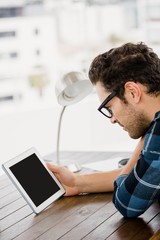Young man using digital at his desk