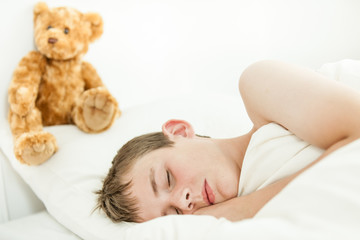 Adorable boy sleeping with plush bear