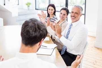 Workers are applauding and smiling thanks to someone