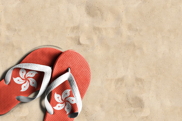 Thongs with flag of Hong Kong, on beach sand