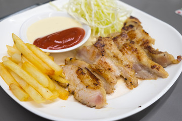 steak with french fries and salad