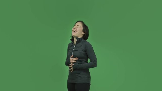 caucasian sporty girl isolated on green screen laughing funny