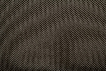 Dark brown fishnet cloth material as a texture background.