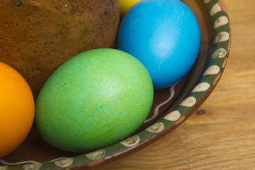 Easter eggs of different colors and cake