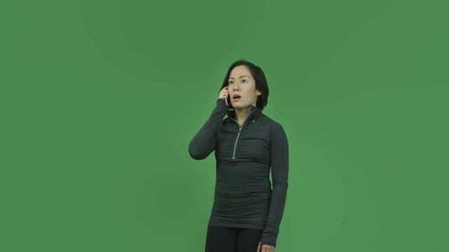 caucasian sporty girl isolated on green screen upset with cell phone