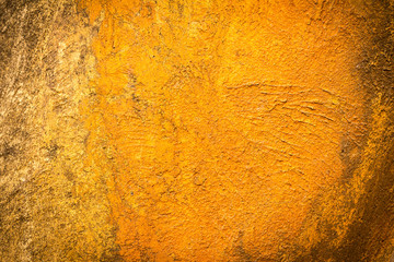 Abstract background texture cement wall in  orange yellow tone.