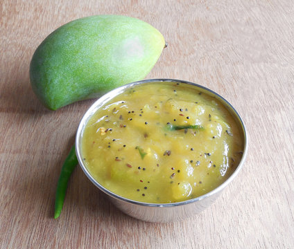 Raw mango curry in a steel bowl.