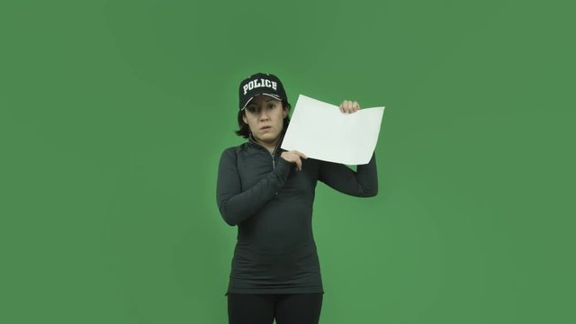 caucasian police girl isolated on green screen upset with blank sign