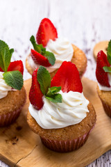 Homemade buttercream cupcakes with strawberries