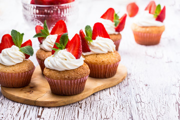Homemade buttercream cupcakes with strawberries