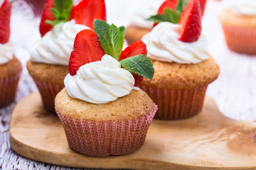 Homemade buttercream cupcakes with strawberries