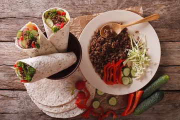 Sandwich roll with beef and fresh vegetables. horizontal top view
