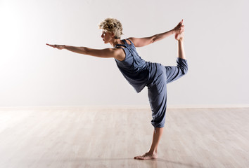 Woman in perfect balance while holding foot