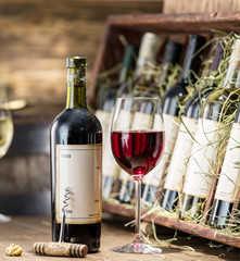 Glass of wine and wine bottle. © volff