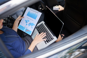 Fototapeta premium Business woman working with diagram in car