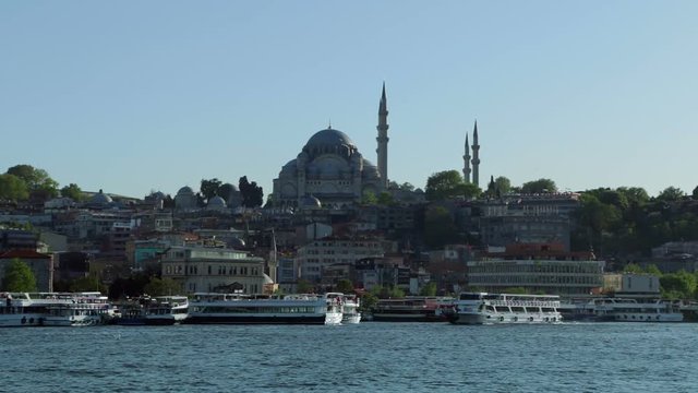 Turkey. Istanbul. Sunny and cloudless day. View of the Rustem Pasa Mosque and pleasure boats