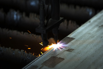 Metal cutting with acetylene torch close-up on low ligth