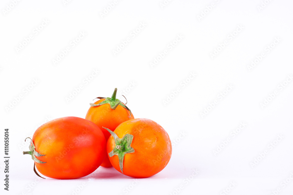 Wall mural fresh red tomatos is high in vitamin c vegetables fruit food on the white background isolated