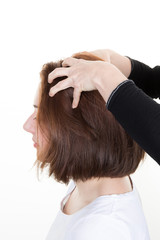 Woman getting a massage while having hair cut at salon by hairdresser