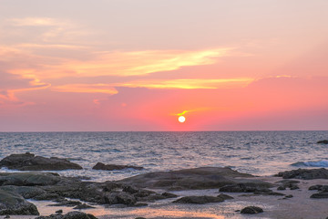 Sea , sand and rocks at the sunset.