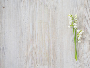 lilies of the valley on the wooden surface