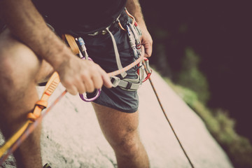 Climber holding a rope on a stone wall