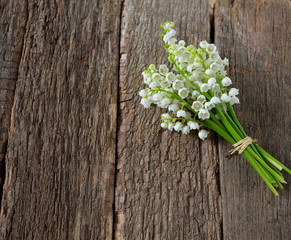 lilies of the valley on the wooden surface