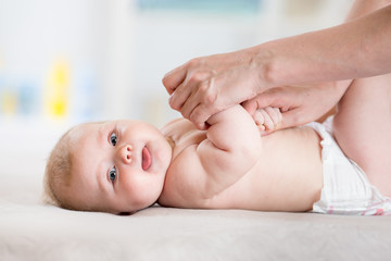 Mother massaging her baby girl