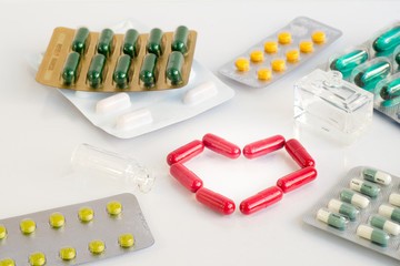 Red heart pill .Represents medication for heart disease