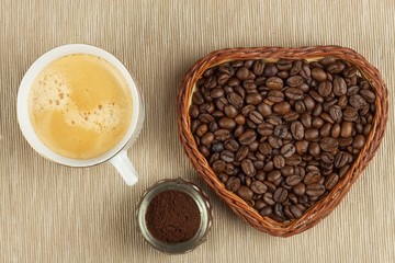 Roasted coffee beans on the kitchen table. Fresh coffee. Preparation of hot coffee. Refreshing drink. Sales of coffee beans. Advertising for coffee shop. We love fresh coffee.

