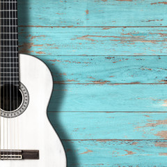 Obraz premium White classical guitar on vintage wood background with copy space.