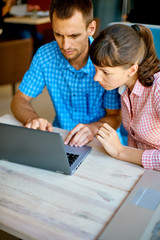 young man and woman with laptop