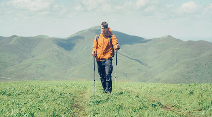 Fototapeta na wymiar Hiker man walking in the mountains