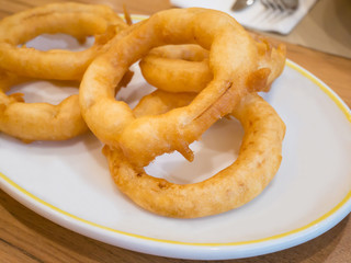 fried onion rings on white plate